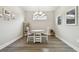 Eat-in dining area with wood floors, modern chandelier and natural light at 11125 Callisia Dr, Odessa, FL 33556