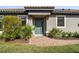 Inviting front entrance with a teal door, brick pathway, and lush landscaping at 11125 Callisia Dr, Odessa, FL 33556