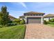 Well-maintained home with a two car garage, beautiful landscaping, and a paver driveway at 11125 Callisia Dr, Odessa, FL 33556