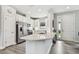 Modern kitchen featuring white cabinets, stainless steel appliances, and a breakfast bar at 11125 Callisia Dr, Odessa, FL 33556