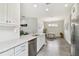 Bright kitchen boasts white cabinets, stainless appliances, granite counters and eat-in dining area at 11125 Callisia Dr, Odessa, FL 33556