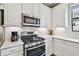 Updated kitchen featuring stainless steel appliances, white cabinets, and tiled backsplash at 11125 Callisia Dr, Odessa, FL 33556