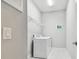 Bright laundry room with updated appliances and convenient overhead shelving for optimal storage at 11125 Callisia Dr, Odessa, FL 33556