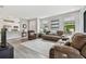 Open-concept living room with wood floors, neutral paint and backyard views at 11125 Callisia Dr, Odessa, FL 33556