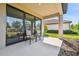 Covered outdoor patio featuring neutral toned furniture and access to a lush backyard at 11125 Callisia Dr, Odessa, FL 33556