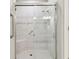 Tiled shower with a glass door, bench, and showerhead at 11125 Callisia Dr, Odessa, FL 33556