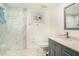 Updated bathroom with gray vanity and a walk-in shower at 11828 Bingham Dr, Port Richey, FL 34668