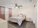 Charming bedroom with ceiling fan and pink bedding at 11828 Bingham Dr, Port Richey, FL 34668