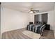 Bright bedroom with wood-look floors and ceiling fan at 11828 Bingham Dr, Port Richey, FL 34668