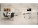 Modern dining area with a white table and gray chairs at 11828 Bingham Dr, Port Richey, FL 34668