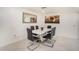 Elegant dining room featuring a modern white table and six chairs at 11828 Bingham Dr, Port Richey, FL 34668