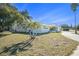 Side view of the house showcasing a well-maintained lawn at 11828 Bingham Dr, Port Richey, FL 34668
