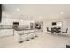 Open concept kitchen with granite island and white cabinetry at 11828 Bingham Dr, Port Richey, FL 34668