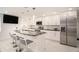 Renovated kitchen featuring granite island and stainless steel appliances at 11828 Bingham Dr, Port Richey, FL 34668