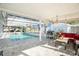 Relaxing screened pool area with patio furniture at 11828 Bingham Dr, Port Richey, FL 34668