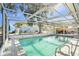 Inviting screened pool with patio and seating area at 11828 Bingham Dr, Port Richey, FL 34668