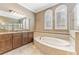Elegant bathroom with double vanity, soaking tub, and large windows at 125 Falling Water Dr, Brandon, FL 33511