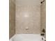 Bathroom with bathtub and beige tile surround at 125 Falling Water Dr, Brandon, FL 33511
