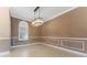 Bright dining room with large window and stylish chandelier at 125 Falling Water Dr, Brandon, FL 33511