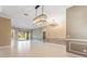 Open dining room with large chandelier and tile floors at 125 Falling Water Dr, Brandon, FL 33511