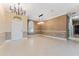 Spacious dining room with large chandelier and neutral decor at 125 Falling Water Dr, Brandon, FL 33511