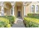 Elegant entryway with arched columns and lush landscaping at 125 Falling Water Dr, Brandon, FL 33511