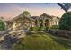 Tan two-story house with a three-car garage and manicured lawn at 125 Falling Water Dr, Brandon, FL 33511