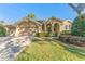 Two-story house with a large yard, driveway and mature trees at 125 Falling Water Dr, Brandon, FL 33511
