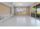 Bright Gathering room featuring tile floors, built-in shelving, and sliding glass doors at 125 Falling Water Dr, Brandon, FL 33511