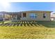 House exterior with pergola, stone patio and grass at 125 Falling Water Dr, Brandon, FL 33511