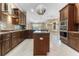 Spacious kitchen with island, stainless steel appliances, and dark wood cabinets at 125 Falling Water Dr, Brandon, FL 33511