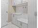 Laundry room with white cabinets, bench, and washer/dryer at 125 Falling Water Dr, Brandon, FL 33511