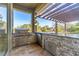 Outdoor kitchen with stainless steel grill and stone countertops at 125 Falling Water Dr, Brandon, FL 33511