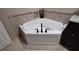 Corner bathtub with tile surround and modern fixtures at 13504 Red Ear Ct, Riverview, FL 33569