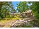 Large backyard with mature trees and a spacious grassy area at 1511 Prescott S St, St Petersburg, FL 33712