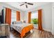Bedroom with orange curtains and a patterned bedspread at 1511 Prescott S St, St Petersburg, FL 33712