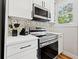 Modern kitchen with white cabinets and stainless steel appliances at 1511 Prescott S St, St Petersburg, FL 33712