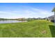 Spacious backyard with a large grassy area and pond view at 16120 67Th E Ct, Parrish, FL 34219