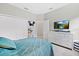 Spacious bedroom with a dresser and large TV at 16120 67Th E Ct, Parrish, FL 34219