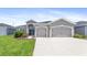 Two-car garage and front yard at 16120 67Th E Ct, Parrish, FL 34219