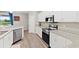 Modern kitchen with stainless steel appliances and granite counters at 16120 67Th E Ct, Parrish, FL 34219