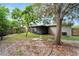 Large backyard with a screened porch and mature trees at 1613 Alhambra Crest Dr, Ruskin, FL 33570