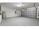 Spacious garage with painted floor at 16523 Myrtle Sand Dr, Wimauma, FL 33598