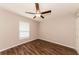 Bright bedroom with wood-look floors and ceiling fan at 19474 Strathcona Ave, Port Charlotte, FL 33954