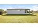 House exterior showcasing a gray house and grassy yard at 19474 Strathcona Ave, Port Charlotte, FL 33954