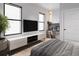 Modern bedroom with large windows, TV, and built-in workspace at 2100 4Th S St, St Petersburg, FL 33705