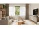 Bright living room featuring a comfortable sofa and modern shelving at 2100 4Th S St, St Petersburg, FL 33705