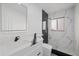 Modern bathroom with white vanity, walk-in shower, and marble tile at 2307 Mary Sue St, Largo, FL 33774