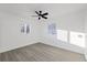 Bright bedroom with ceiling fan, wood-look floors, and large windows at 2307 Mary Sue St, Largo, FL 33774