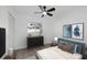 Bedroom with ceiling fan, wood-look floors, and blue accents at 2307 Mary Sue St, Largo, FL 33774